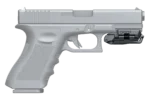 A gray handgun with a tactical attachment on the rail.
