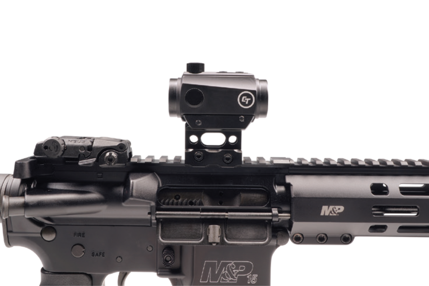 A tactical rifle with a mounted sight and safety selector switch visible.