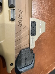 Close-up of a P365 handgun slide with a Holosun sight attached.