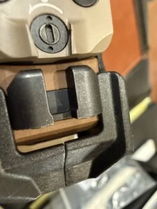 Close-up of a device with a screw mechanism and black handle components.