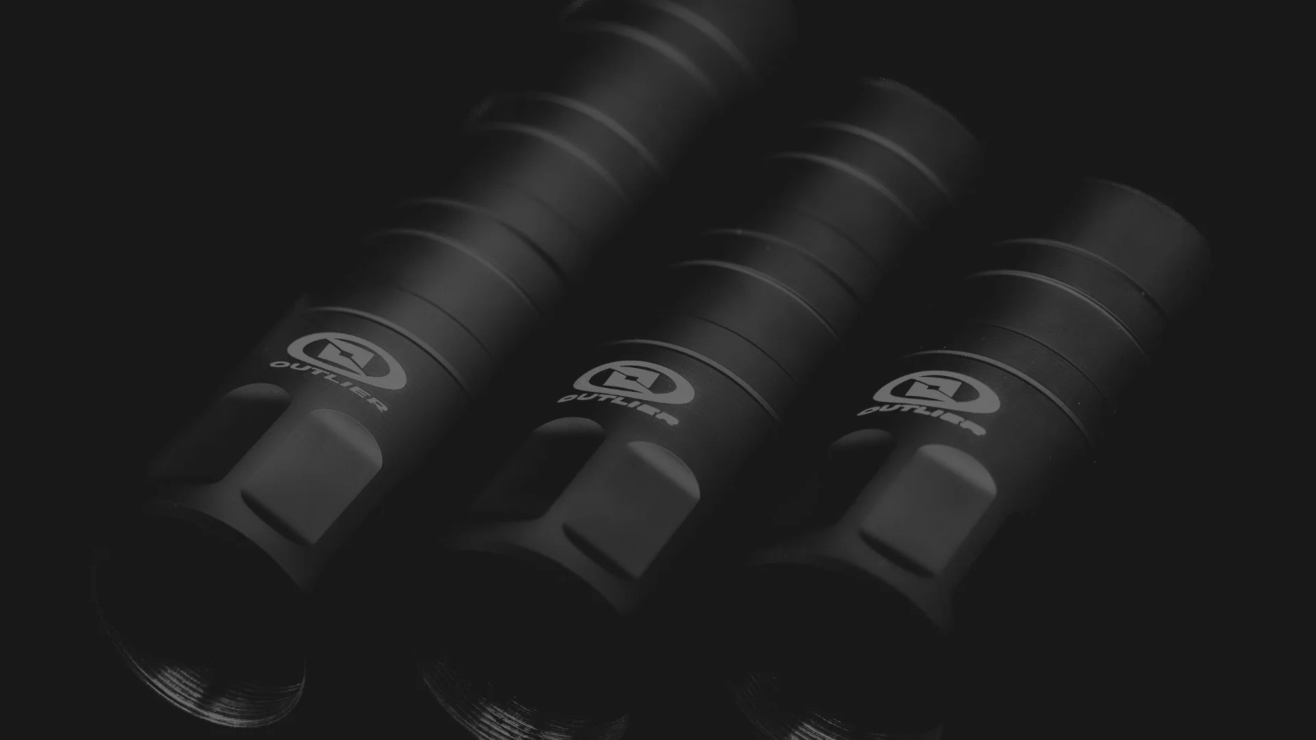 Three black flashlights with logos on a dark background.